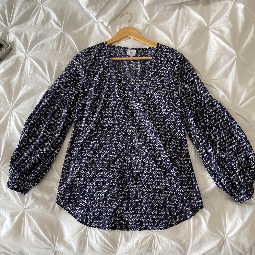 CAbi navy puffy sleeve blouse.  Dark navy with purple/white lettering.